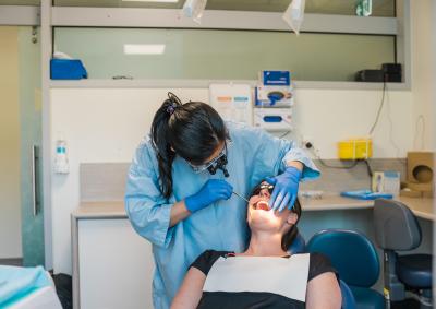 A dentist examining a patients mouth.