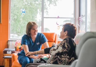 An older person talking to a THS worker about their health.