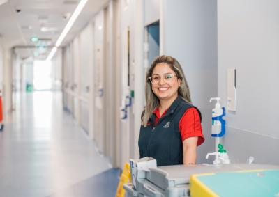 A hospital worker smiling in the hallways of Royal Hobart Hospital.