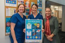 Tasmanian Burns Unit team in front of posters