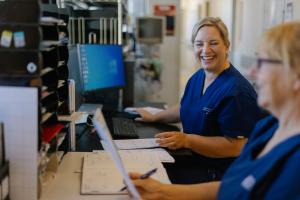 A nurse smiling to another nurse